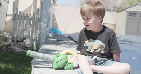 Kid Playing With Bubble Machine Stock Footage 283962793