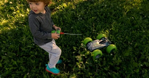 Kid playing with car on remote control Stock Footage 112600315