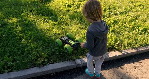 Kid playing with car on remote control Stock Footage 113190533