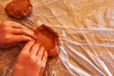 Kid playing with clay Stock Photos