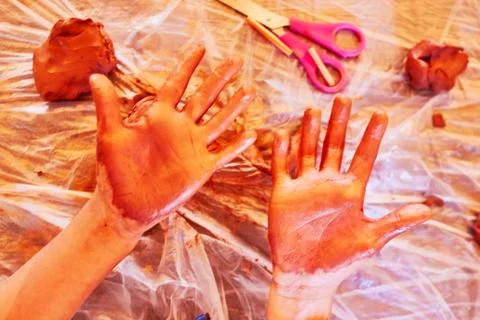 Kid playing with clay Stock Photos