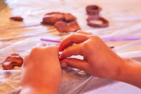 Kid playing with clay Stock Photos