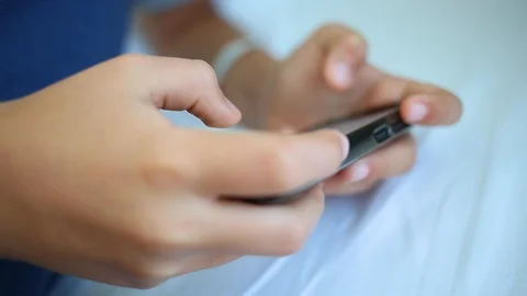 Kid playing computer games using modern black smartphone. Close up of hands Stock Footage 94772259