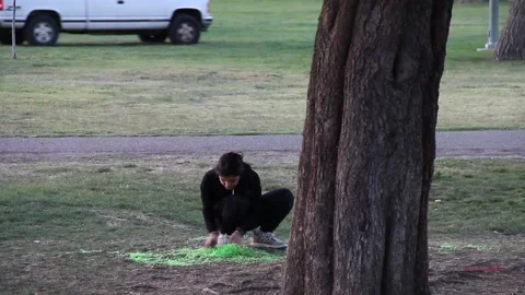 Kid playing with confetti in the park Stock Footage 154992507