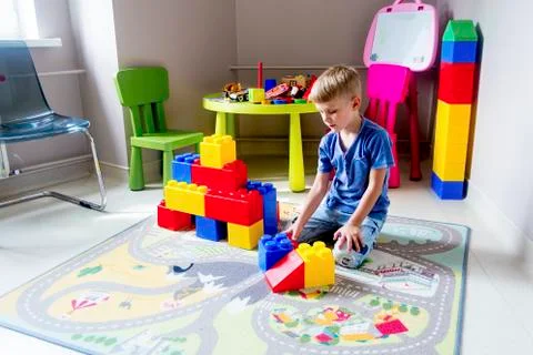 Kid playing with construction blocks Stock Photos