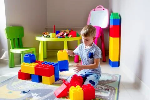 Kid playing with construction blocks Stock Photos