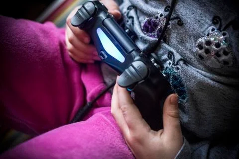 Kid playing with a controller Stock Photos