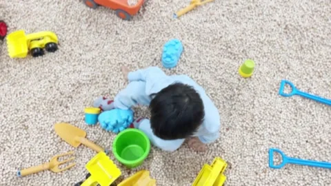 A kid playing on the Cypress Wood Cube Stock Footage 262865697