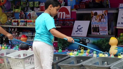 A kid playing at a fairground Stock Footage 78487498