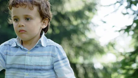 Kid playing in the forest when suddenly his brother hits him with a wooden stick 库存影片 98567306