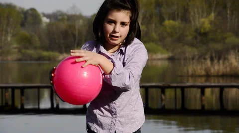 Kid is playing with a fuchsia ball Video stock 33196066