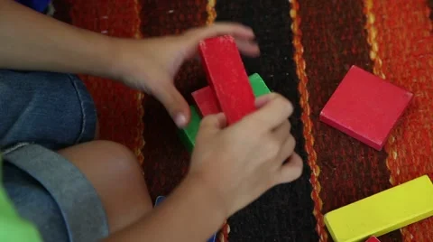 Kid playing with geometric pieces Stock Footage 64737971