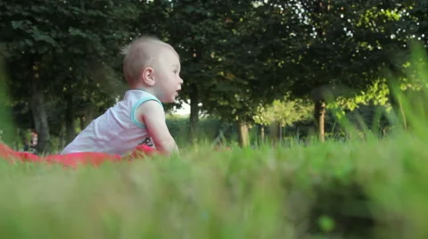 The kid playing on the grass Stockbeeldmateriaal 54937171