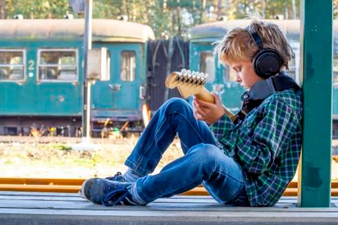 Kid playing guitar Stock Photos