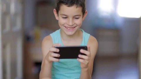 Kid playing mobile game on smartphone Stock Footage 111970488