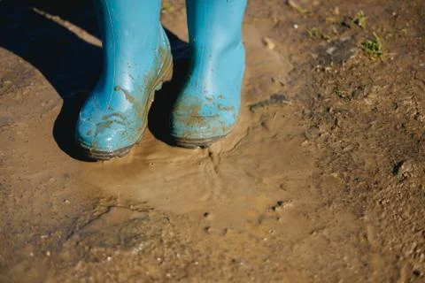 Kid playing in mud Stock Photos