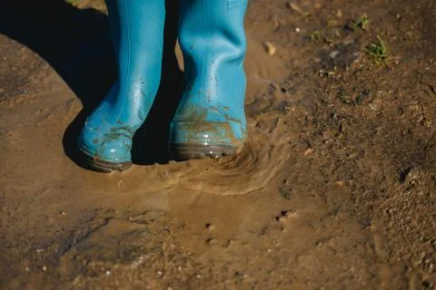 Kid playing in mud Stock Photos