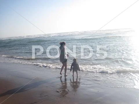 Kid playing in Ocean Stock Photos