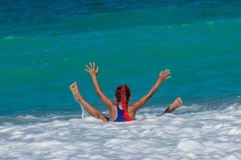 Kid playing in the ocean waves Stock Photos