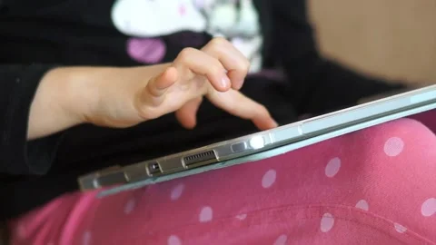 Kid playing pad games. Home entertainment, digitalization in education. Computer Stock Footage 232796437