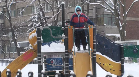 Kid Playing In Park During Snow Storm Medium-Shot Video stock 34974584