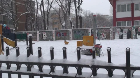 Kid Playing In Park During Snow Storm Pan-Shot Stock Footage 34976062