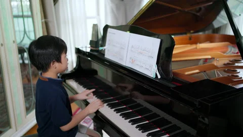 Kid playing piano Stock Footage 161066395