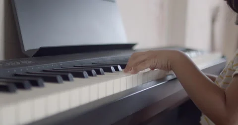Kid playing piano Stock Footage 165089979