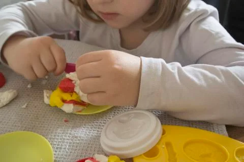 Kid Playing with Plasticine Stock Photos