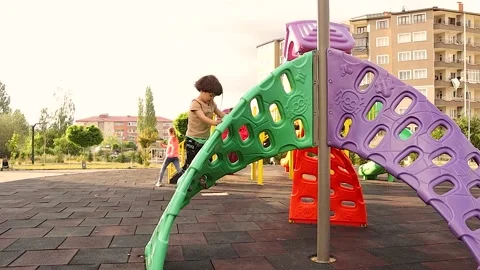 Kid Playing in Playground Expressing Joy and National Pride Abroad Stock Footage 325025556