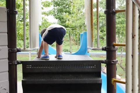 A Kid Playing on a Public Park Slide Stock Footage 65008142