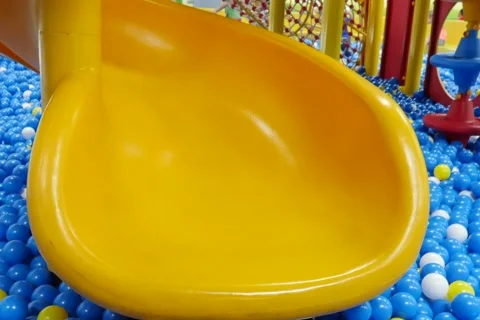 A Kid Playing on a Public Park Slide Stockbeeldmateriaal 65008322