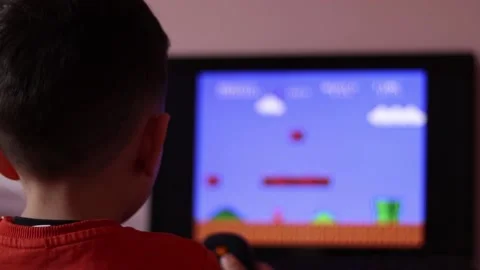 Kid playing a retro game Stock Footage 189341435