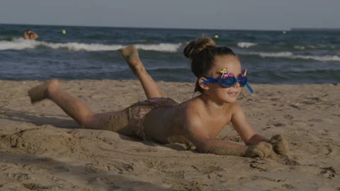 Kid Playing Sand and laying On The Sea Beach Stock Footage 236448383