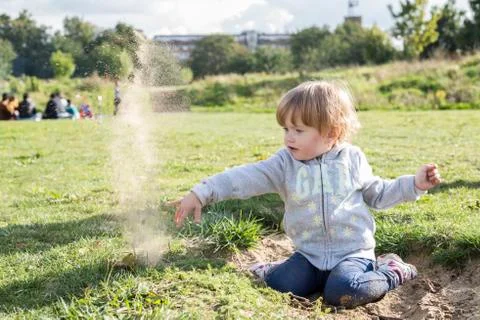 Kid playing with sand Stock Photos