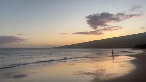 A kid playing at the seashore during sunset Video stock 269833621
