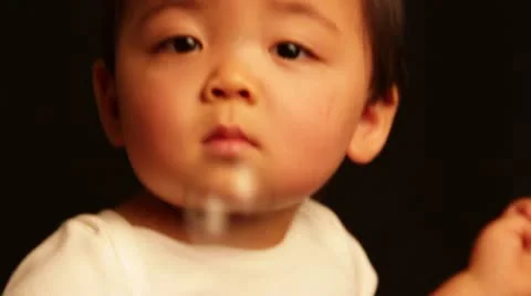 Kid playing with soap bubbles with a keen interest Stock Footage 22413257