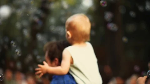 Kid Playing with Soap Bubbles Summer time Stock Footage 127626586