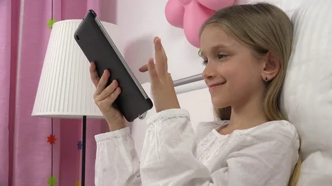 Kid Playing Tablet in Bed, Child Browsing Internet on Touchscreen Smartphone Stock Footage 75657399