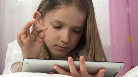 Kid Playing Tablet in Bed, Child Browsing Internet on Touchscreen Smartphone Stock Footage 80081694