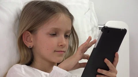 Kid Playing Tablet in Bed, Child Browsing Internet on Touchscreen Smartphone Stock Footage 80082293