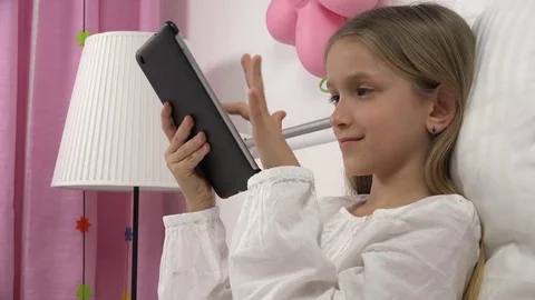 Kid Playing Tablet in Bed, Child Browsing Internet on Touchscreen Smartphone Stock Footage 80108655