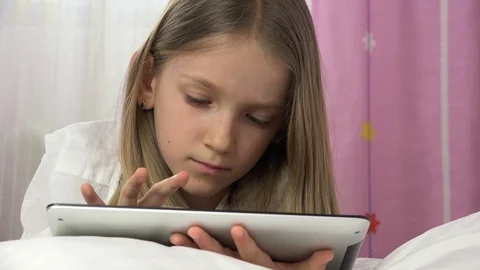 Kid Playing Tablet in Bed, Child Browsing Internet on Touchscreen Smartphone Stock Footage 84890057