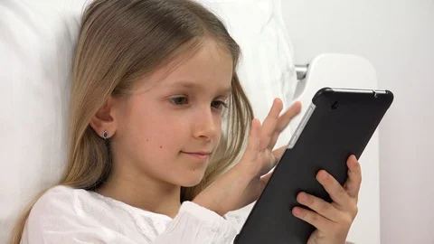 Kid Playing Tablet in Bed, Child Browsing Internet on Touchscreen Smartphone Stock Footage 129368494