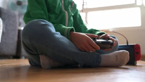 Kid playing with a video game console at home Stock Footage 116270416