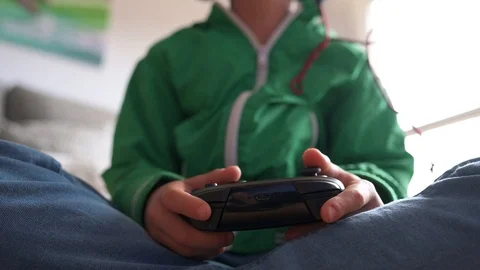 Kid playing with a video game console at home Stock Footage 116270424