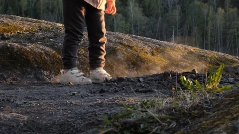 Kid plays and makes dust with legs, slow motion, 60 fps Stock Footage 129197924