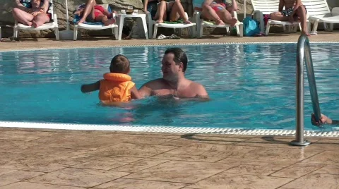 Kid plays with dad in the pool Stock Footage 668649