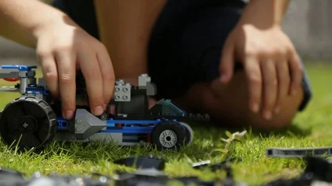 Kid Plays with a LEGO car 스톡 동영상 119200764