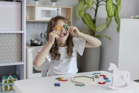 The kid plays with the multi-colored anti-stress toy Stock Photos